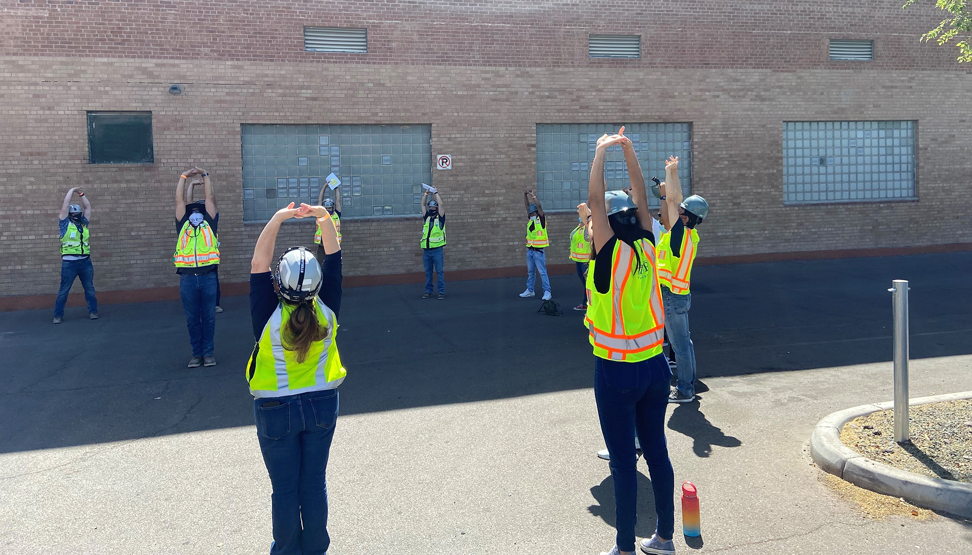 Students stretch before walking the jobsite.