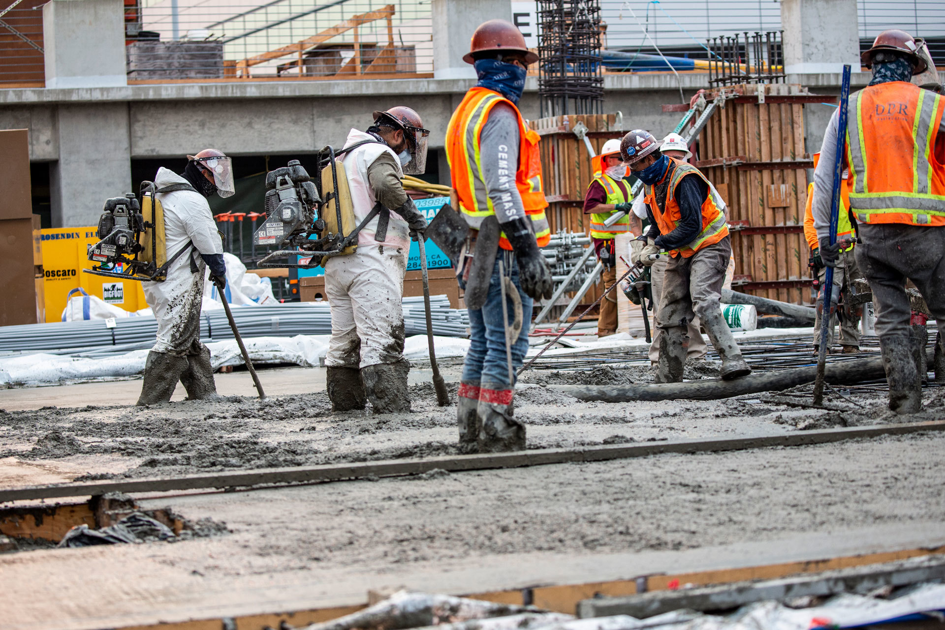 A group of workers lays concrete at a project in Sacramento, CA. 
