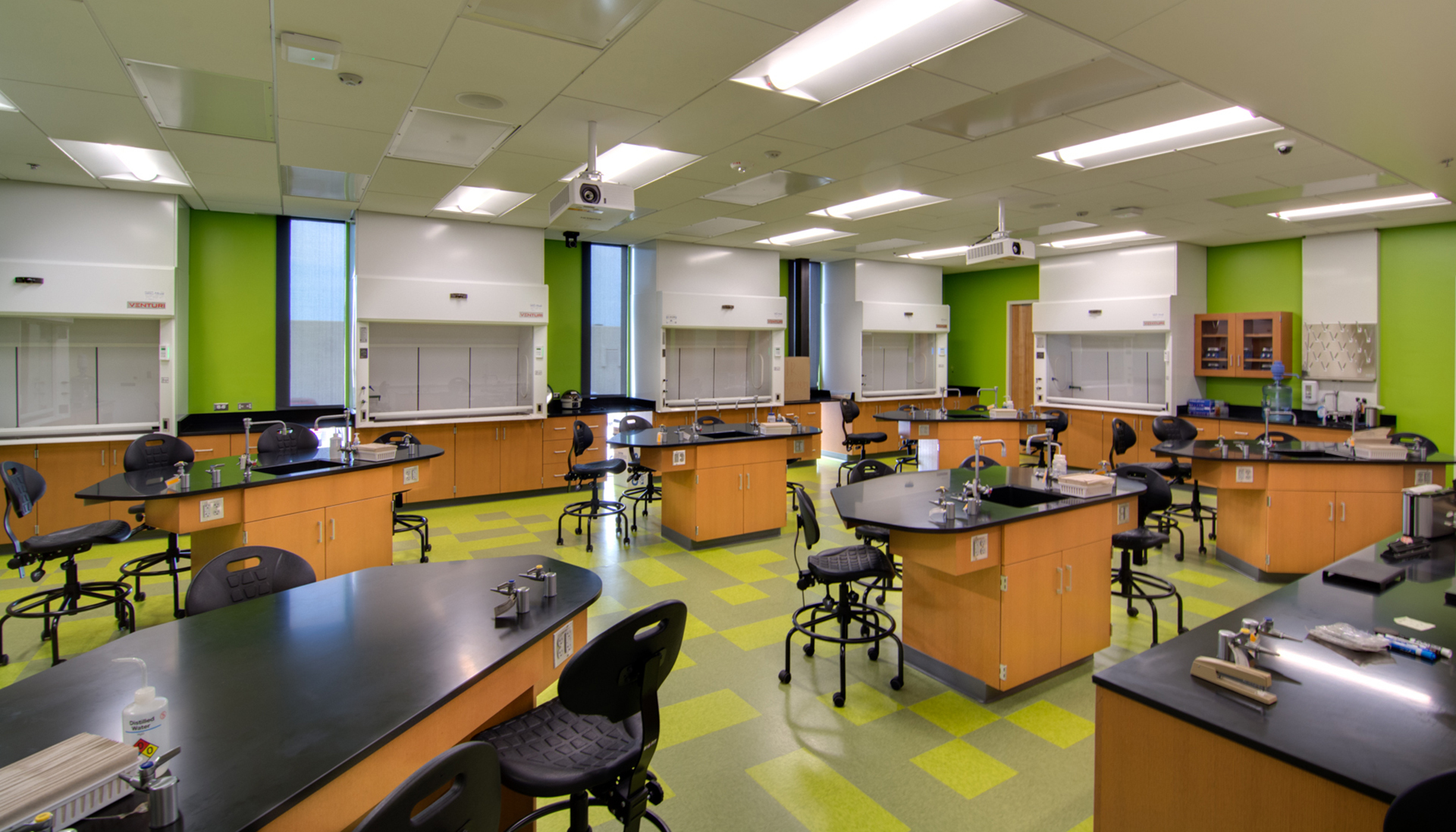 A science classroom at CAC featuring lab tables and fume hoods.